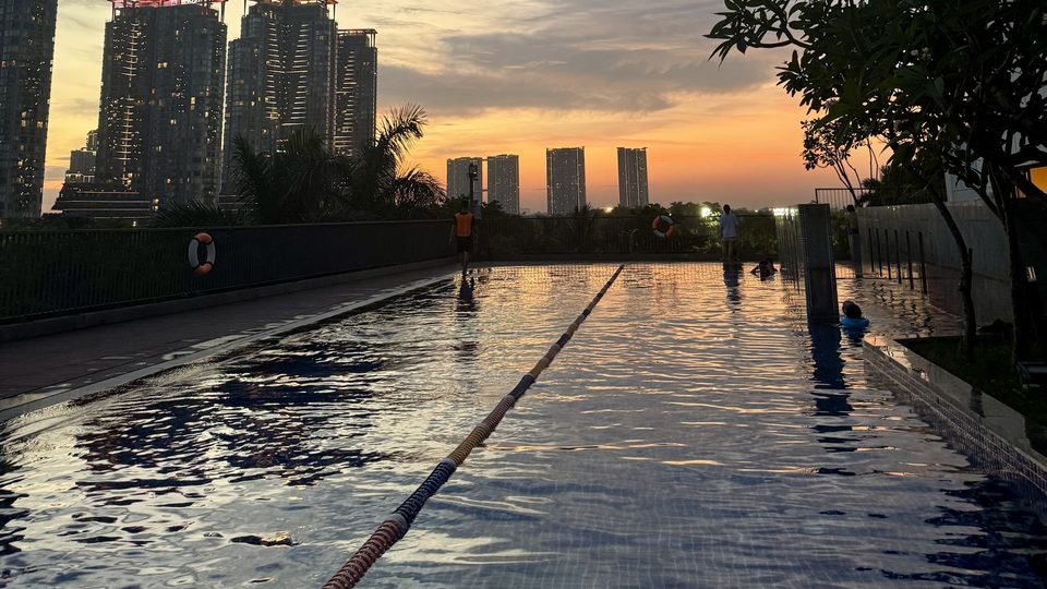 Outdoor pool of an apartment tower at sunset