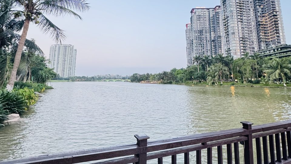 Wooden boardwalk by the lake facing apartment towers